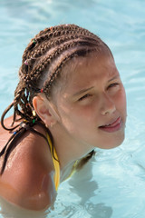 portrait of the sunburnt girl which sits in water for shoulders