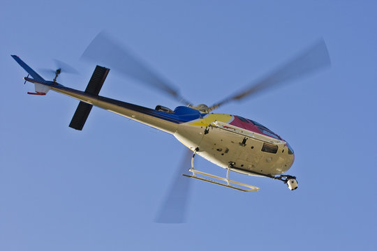 A Helicopter With A Camera. A Motion Blur On Rotor Blades