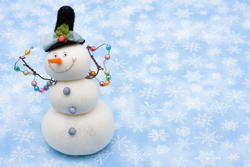 Snowman on blue snowflake background, merry Christmas