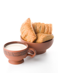 Appetizing pie and cup of milk on a white background