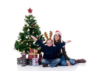 Christmas, happy mother and son, child next to Xmas tree