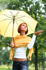 beautiful young girl under yellow umbrella