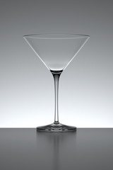 Empty cocktail glass isolated over a gray background.