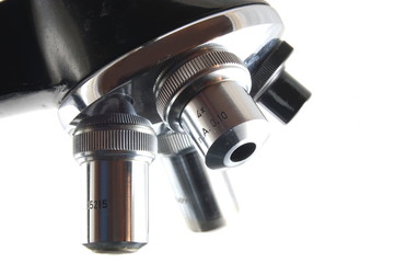Old microscope isolated on a white background