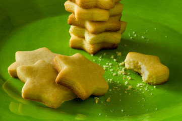 Star shaped sugar cookies on a vibrant green plate