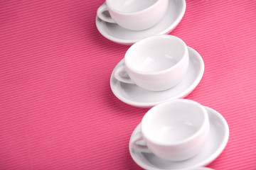 Empty white cup on the pink background