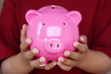 Boy Holding Piggy Bank With His Savings