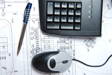 Mouse, keyboard and pen on a construction plan