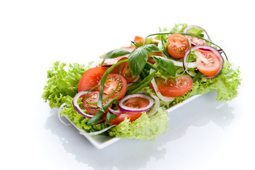 Fresh salad with onion, tomato and basil