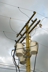 Low angle view of a set of power line transformers