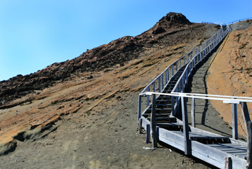 Wooden stairs lead to the top of a mountain