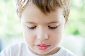 a portrait of a boy thinking, shallow DOF