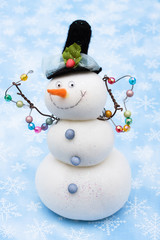 Snowman on blue snowflake background, merry Christmas