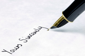 Fototapeta premium Yours Sincerely written on paper using a gold fountain pen.