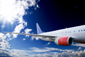 An airplane flying in the sky against a dramatic background