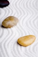 Japanese zen rock garden with white raked sand