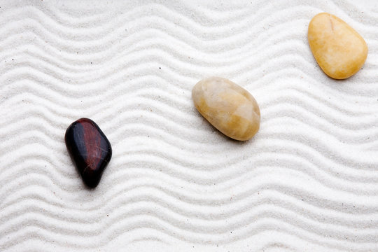 Japanese zen rock garden with white raked sand
