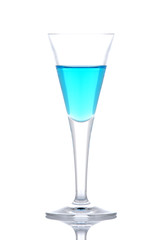 Glass of blue paradise cocktail reflected on white background