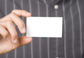 Blank business card held in hand by business person