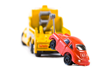 Red car being towed away by yellow tow truck (2)