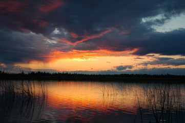 Colorful sunset reflecting on small lake in Northern, Ontario