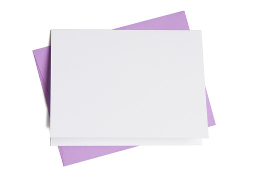 Blank greeting card on top of colored envelope
