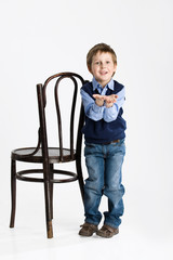 Little boy sitting on an old bent-wood chair