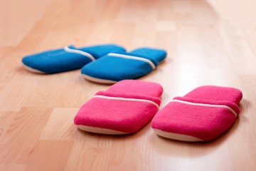 Two pairs of slippers on the parquet