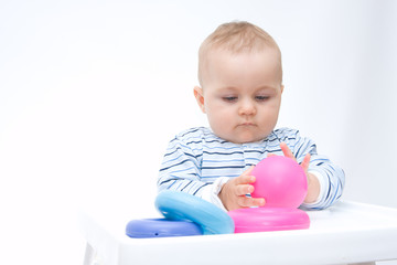 cute baby boy playing with colorful toys