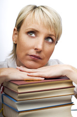 young blond woman with stack of books close up