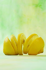 Fototapeta na wymiar sliced fresh lemon, green background