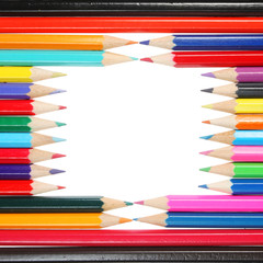 Colored pencils form a frame white copy space in center