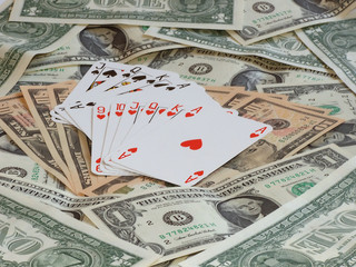 hearts poker and poker game against background made of dollars