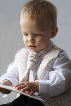 little pageboy looking at card
