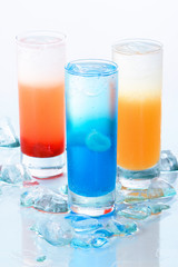 Three colourful drinks