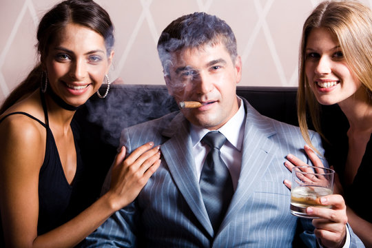 Portrait of successful man smoking a cigar