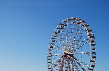 Ferris wheel on background blue sky