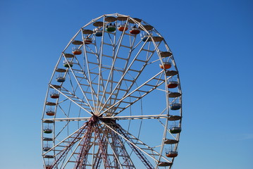 Ferris wheel on background blue sky