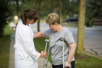 helping a patient with crutches
