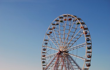 Ferris wheel on background blue sky