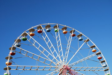 Ferris wheel on background blue sky