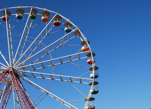 Ferris wheel on background blue sky