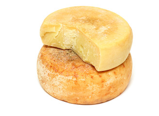 Two pieces of ripe peasant cheese in a stack