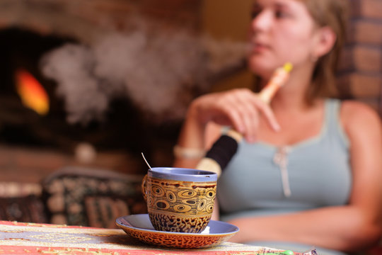 The Girl Smokes Hookah In A Turkish Cafe