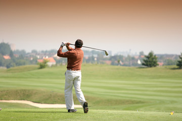 Golfer in bussy saint georges hole 7, france, hitting shot