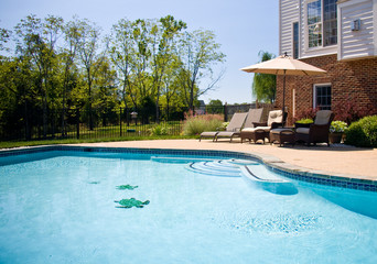 Swimming Pool looking past a set of comfortable seats