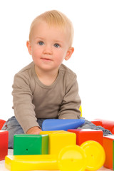 little boy play with bricks. isolated on a white background