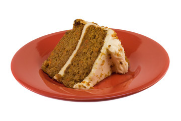 piece of fresh, moist carrot cake isolated on a red plate