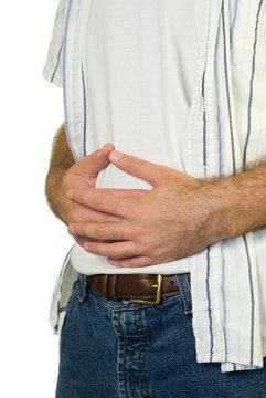 A man with a sore tummy holding it in pain