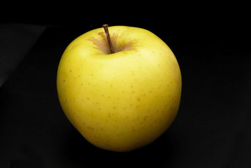 Yellow apple on black